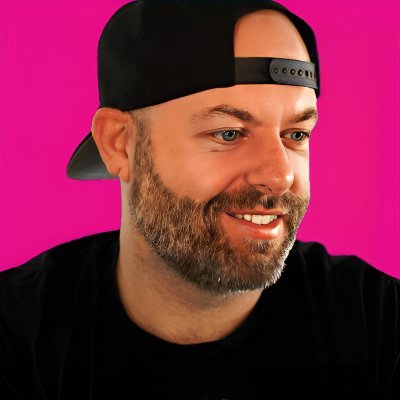 Shealan smiling and wearing a baseball cap.